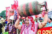 A woman protests against the fuel price hike in Bhubaneswar