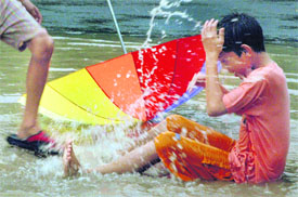 Roadside splash Kids let loose in a puddle as monsoon rain lashed Chandigarh on Sunday.