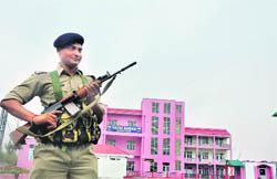 A CRPF jawan stands guard outside a base camp for the Amarnath yatra in Bhagwati Nagar in Jammu on Sunday.