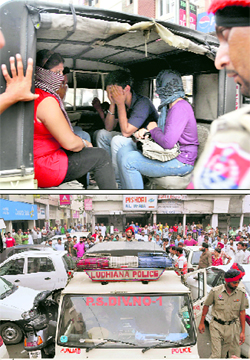 (Above) The accused who were arrested from a hotel during a raid in Ludhiana on Sunday; and (below) onlookers gather at the spot of police action