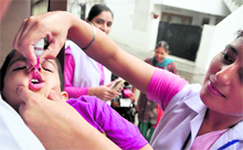 A volunteer administers polio drops to a child during the pulse polio drive in Ludhiana on Sunday
