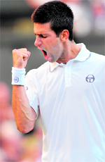 Novak Djokovic celebrates a point against Marcos Baghdatis in London, on Saturday