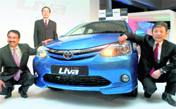 Toyota's Managing Officer Hiroji Onishi (2nd L), along with collegaues, poses with the newly-launched hatch back car "Etios Liva" in New Delhi on Monday. The car is priced between Rs 3.99 lakh and Rs 5.99 lakh (ex- showroom, Delhi) and will be available in four variants J, G, V and VX. The Japanese auto major has also invested Rs 3,200 crore to set up its second manufacturing facility in Bangalore with an initial installed capacity of 70,000 units per annum
