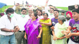 Residents stage a protest against MC authorities on Monday.
