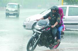 A couple enjoys rains in New Delhi