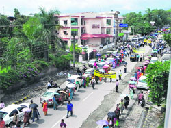 Striking Class IV employees of the state government take out a procession in Dehradun on Monday.