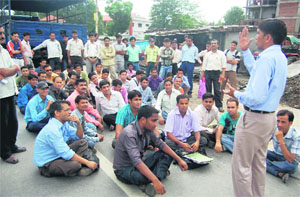 Members of the BEd/BPEd Prashikshit Mahasangh hold a protest in Dehradun on Monday. 