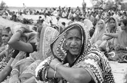 Villagers sit along the entry point to prevent policemen and officials from entering their land at Jagatsinghpur district, about 140 kilometres east of Bhubaneswar
