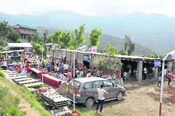 Amarnath yatris at a community kitchen at Kud on the Jammu-Srinagar National Highway on Monday. 