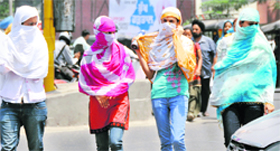 Girls cover their faces to escape sweltering heat in Ludhiana.