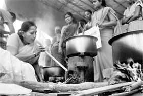 BJP activists prepare food on a chullah during a protest against the hike 