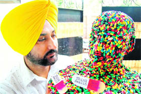 Artist Harwinder Singh Gill shows his creation which he made to mark the International Day against Drug Abuse and Illicit Trafficking in Amritsar.