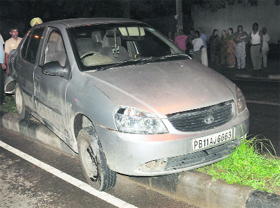Freewheeling A car rests on a median after it hit a woman on the road separating Sectors 27 and 30 in Chandigarh on Tuesday. The woman was injured in the accident and was taken to a hospital.