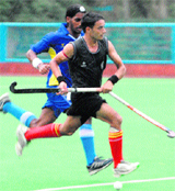 Players chase the ball during the Air Force Hockey Championship at the 3BRD Air Force Station in Chandigarh 