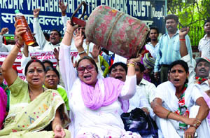 Activists of the Samajwadi Party hold a protest against the price hike of diesel, kerosene and cooking gas in New Delhi on Tuesday.