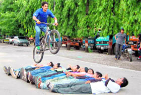 A cyclist shows his skills at the Dehradun Municipal Corporation.