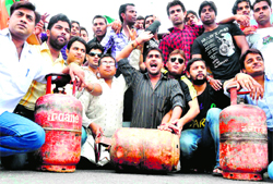 Youths protest against the hike in the price of LPG and blackmarketing in cylinders in Haridwar on Tuesday