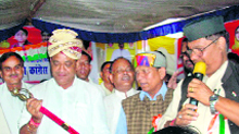 Uttarakhand Congress chief Yashpal Arya is presented with a sword during his "Satyagraha Yatra" at Nainidanda on Tuesday