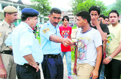 Police officials talk to students on the Postgraduate Valabh College campus in Mandi on Tuesday