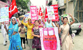 UP IN ARMS: SUCI activists hold a protest march against the hike in the prices of LPG, diesel and kerosene at Rohtak on Tuesday.