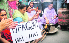 Activists of the BJP Mahila Morcha hold a protest against the hike in fuel prices in Jammu on Tuesday. 
