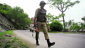 A CRPF jawan guards the Jammu-Srinagar National Highway ahead of the Amarnath Yatra.
