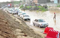 Drivers find it difficult to ply their vehicles on an under-construction inundated road near Rama Mandi in Jalandhar.