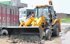 Road repair work in progress on Moga Road in Shahkot.