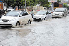 Vehicles make their way through a waterlogged road in Bathinda after the showers on Wednesday.