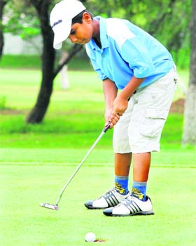 Tanmay prepares to play a shot during a tournament at the Golf Club in Chandigarh on Wednesday
