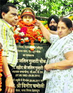 The parents of Jatin Gulati, Assistant Commandant of the CRPF, who died in a Naxal attack last year, unveil his bust in Dehradun on Wednesday