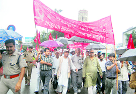 Workers of the CPM hold a protest against price hike and corruption, in Dehradun on Wednesday
