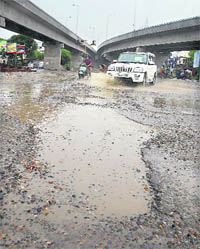 Continuous showers have worsened the condition of roads in Jalandhar. Here seen is the road near BMC Chowk flyover.