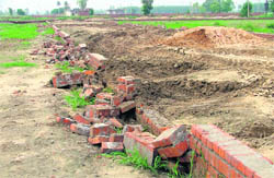 A wall of an illegal colony on the Jassian-Chuharpur road that was razed by the GLADA in Ludhiana.