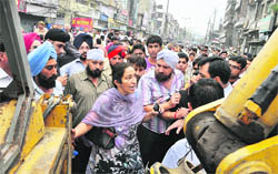 Shopkeepers argue with Assistant Town Planner Kamaljit Kaur
