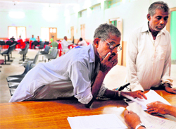 Farmers unwilling to give their land to Tata Motors talk to officials at the office of the district collectorate in Singur, 45 km north of Kolkata, on Wednesday