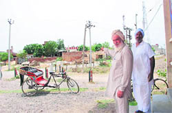 A resident points towards Giani Zail Singhs house in Sandhwan village near Faridkot