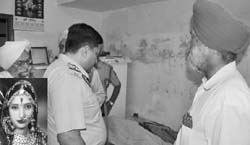 A policeman looks for clues at the house of the victim (inset).