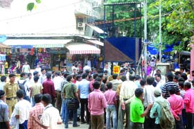People gathered after a remote control found in Sarojini Nagar Market in New Delhi on Thursday