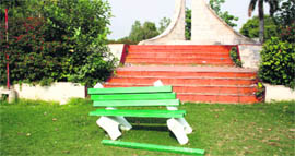 A broken bench in front of a martyrs memorial at Mansarovar park in Rohtak.