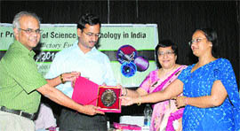 Prof N. Sathyamurthy, director, Society for Promotion of Science and Technology in India, Mohali, honours deputy commissioner CG Rajinikanthan in Kurukshetra.