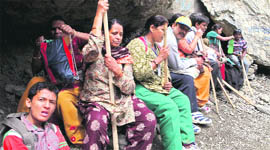Pilgrims take rest as they return after offering prayers at the Amarnath cave shrine on Thursday.