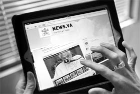 A woman checking the new Vatican portal on an iPad device in Rome. The site is a news information portal that aggregates the Vatican's various media into a one-stop site for all things papal.