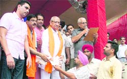 Satpal Gosain hands over an appointment letter to a paramedical employee; 