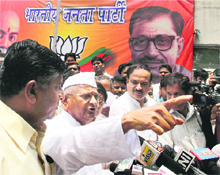 Social activist Anna Hazare, with BJP leaders Ravi Shankar Prasad and Ananth Kumar, talks to the media after a meeting in New Delhi on Friday. 