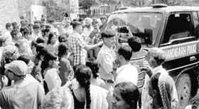 Residents of Colony No. 4 stop a police vehicle at Phase I, Industrial Area, Chandigarh, on Saturday