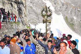 Pilgrims await their turn outside the Amarnath cave shrine to have the darshan of the Ice Lingam on Saturday