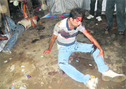 Two injured youths lying on a ground after a group clash at Sherpur in Ludhiana