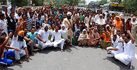 Residents of Bhucho Khurd block the Bathinda-Chandigarh road outside the village on Sunday.