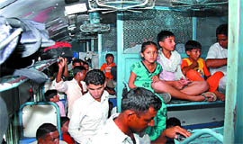 Passengers search for seats inside a bogey of a passenger train at the Bathinda railway station.